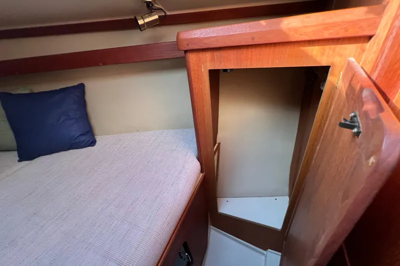 Slide: The Image of Cozy cabin interior of 1990 Hunter Legend 35.5 sailboat with wooden finish and bedding. - 29