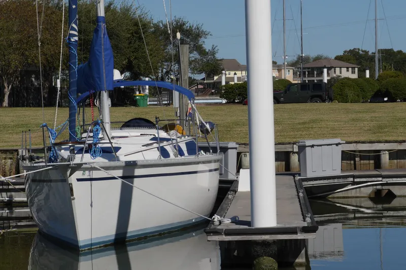 Slide: The Image of 1990 Hunter Legend 35.5 sailboat docked at marina with blue sail cover. - 3