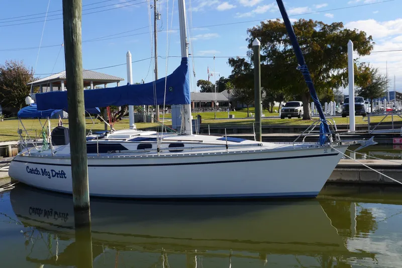 Slide: The Image of 1990 Hunter Legend 35.5 sailboat docked in a marina, blue sail cover. - 4
