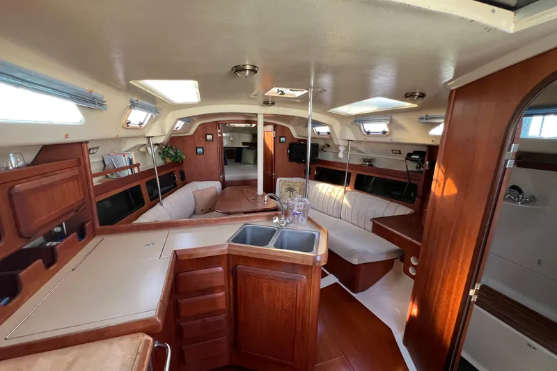 Slide: The Image of Interior of 1990 Hunter Legend 35.5 sailboat with wood finishes and cozy seating area. - 6