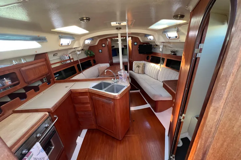 Slide: The Image of Interior of 1990 Hunter Legend 35.5 sailboat with wood finish and cozy seating area. - 9