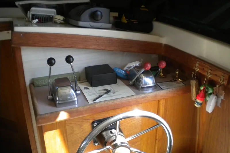 Slide: The Image of 1988 Mainship 40 Double Cabin helm with controls, steering wheel, and nautical decor. - 10