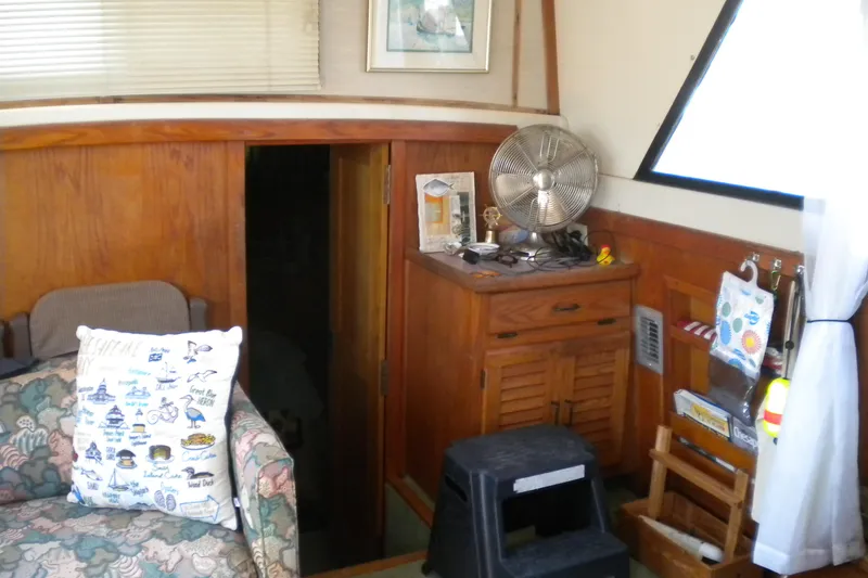 Slide: The Image of Interior of 1988 Mainship 40 Double Cabin with wooden decor and nautical-themed pillow. - 11