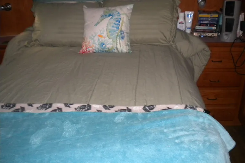 Slide: The Image of Cozy bedroom in 1988 Mainship 40 Double Cabin with seahorse-themed pillow. - 20
