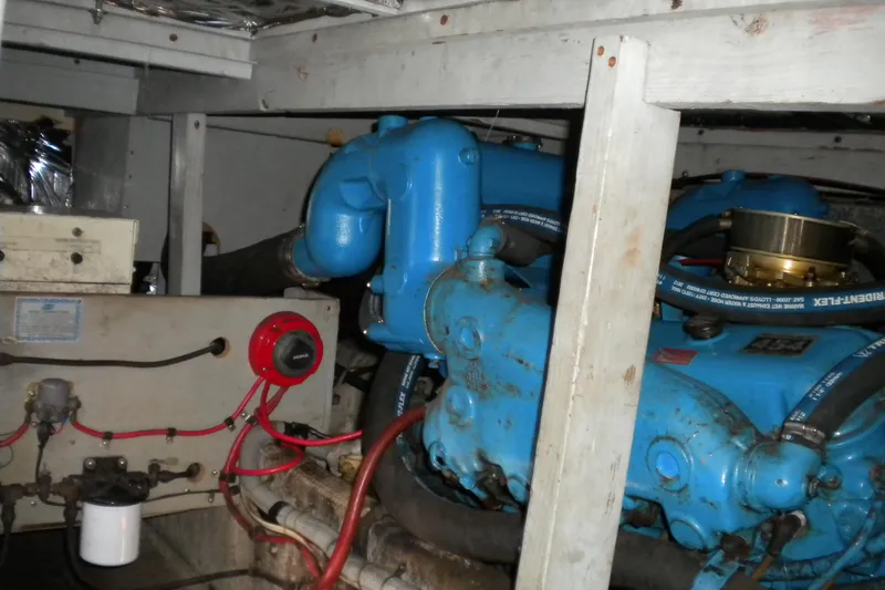 Slide: The Image of Engine room of 1988 Mainship 40 Double Cabin with blue machinery and wiring. - 26