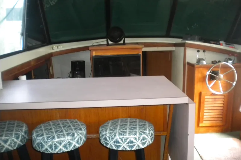 Slide: The Image of 1988 Mainship 40 Double Cabin interior with bar stools and helm station. - 28