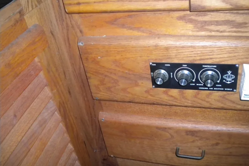 Slide: The Image of 1988 Mainship 40 Double Cabin interior with wooden paneling and control knobs. - 29