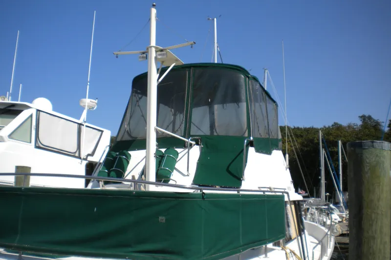 Slide: The Image of 1988 Mainship 40 Double Cabin yacht with green canopy docked at marina. - 3