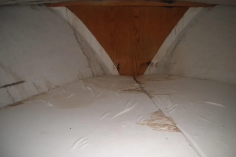 Slide: The Image of Interior cabin view of 1988 Mainship 40 Double Cabin, showing worn bedding and wooden paneling. - 37