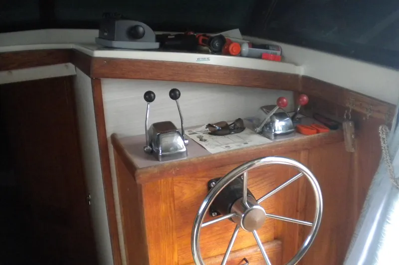 Slide: The Image of 1988 Mainship 40 Double Cabin helm with wooden paneling and steering wheel. - 39