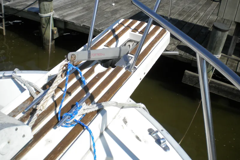 Slide: The Image of 1988 Mainship 40 Double Cabin boat anchor with ropes on wooden deck. - 4