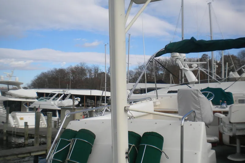 Slide: The Image of 1988 Mainship 40 Double Cabin yacht docked at marina, surrounded by other boats. - 43