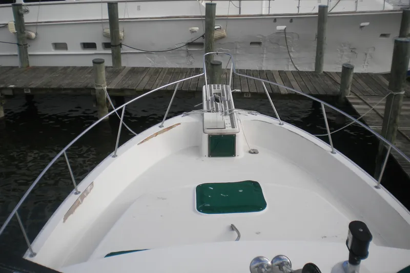 Slide: The Image of 1988 Mainship 40 Double Cabin yacht docked at marina, view from bow. - 45