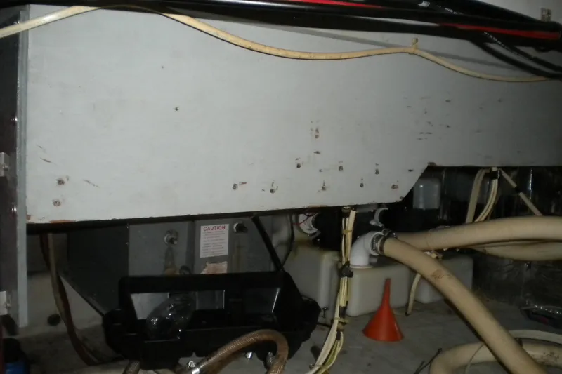 Slide: The Image of 1988 Mainship 40 Double Cabin engine room with hoses and equipment. - 48