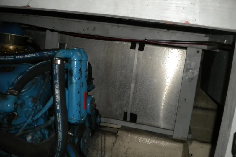 Slide: The Image of Engine compartment of 1988 Mainship 40 Double Cabin with visible blue engine components. - 49
