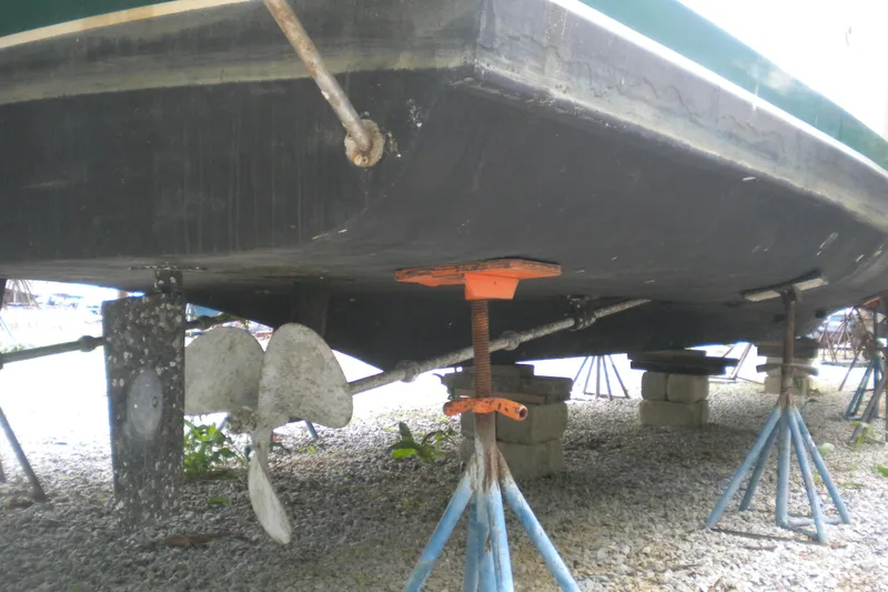Slide: The Image of 1988 Mainship 40 Double Cabin boat hull on stands, showing propellers and supports. - 52