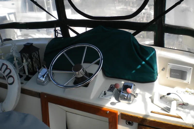 Slide: The Image of 1988 Mainship 40 Double Cabin helm with steering wheel and controls. - 7