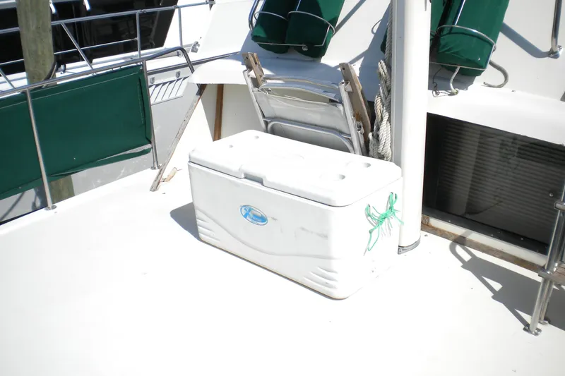 Slide: The Image of 1988 Mainship 40 Double Cabin deck with cooler and green canvas covers. - 9