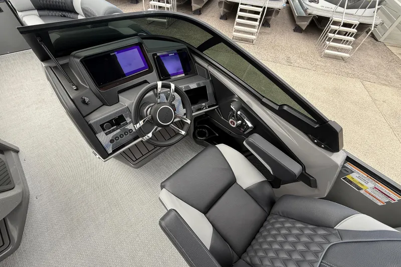 Slide: The Image of Interior of 2026 Avalon 2585 Excalibur LTD boat, featuring modern dashboard and steering wheel. - 19