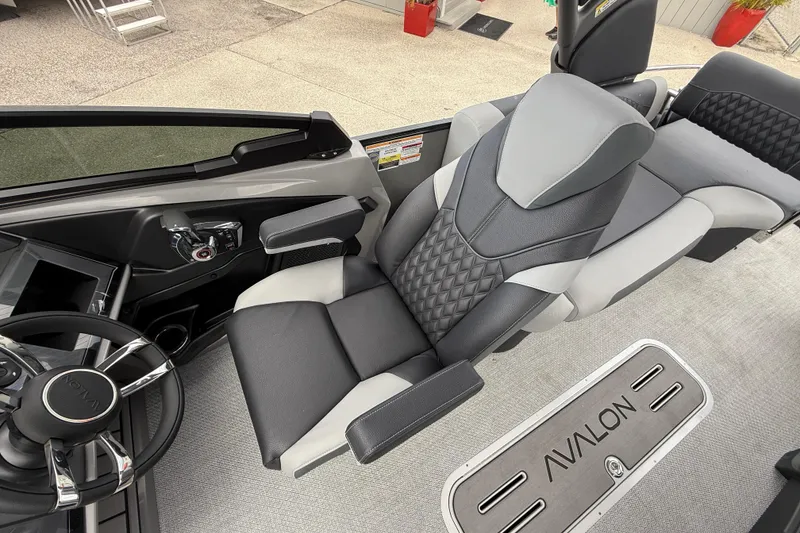 Slide: The Image of Luxurious interior of 2026 Avalon 2585 Excalibur LTD boat with premium seating and steering wheel. - 21