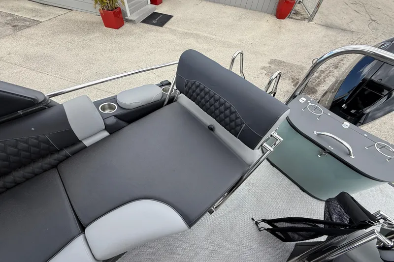 Slide: The Image of Luxurious seating on 2026 Avalon 2585 Excalibur LTD boat with sleek design and cup holders. - 26