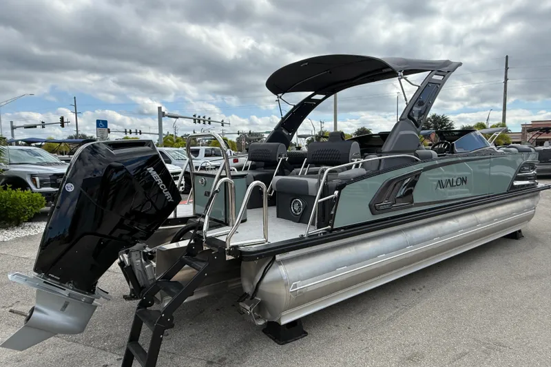 Slide: The Image of 2026 Avalon 2585 Excalibur LTD boat with Mercury 400hp V-10 Verado engine, parked outdoors. - 5
