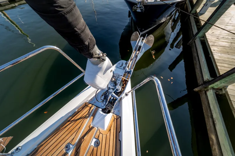 Slide: The Image of Bow of 2016 Jeanneau 64 yacht with anchor and teak deck at marina. - 16