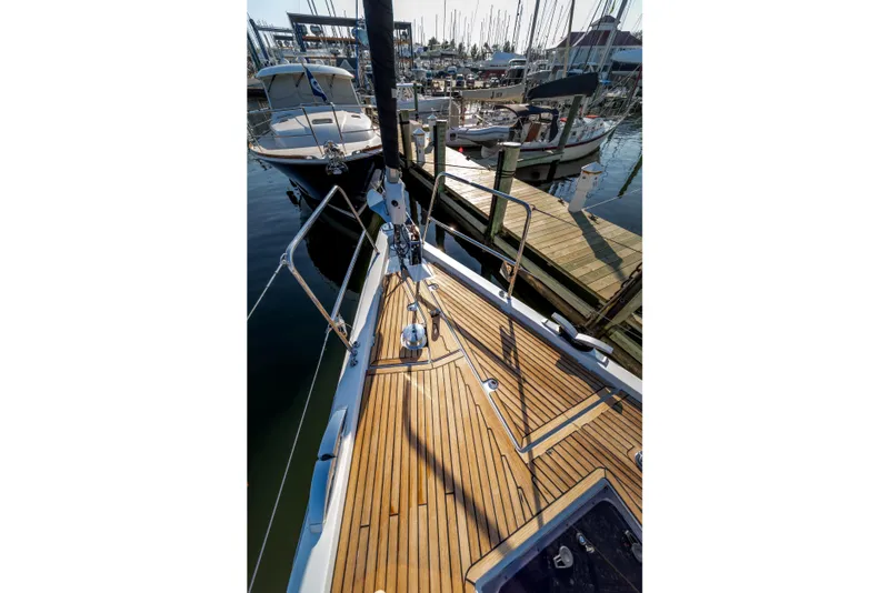 Slide: The Image of Jeanneau 64 sailboat deck, 2016 model, docked at marina with wooden finish. - 17