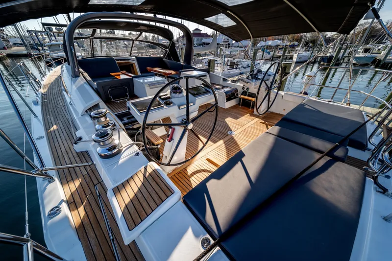 Slide: The Image of Luxurious 2016 Jeanneau 64 yacht cockpit with teak decking and dual steering wheels. - 18