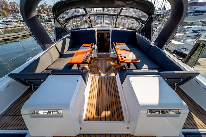 Slide: The Image of Luxurious 2016 Jeanneau 64 yacht deck with elegant seating and wooden tables. - 20