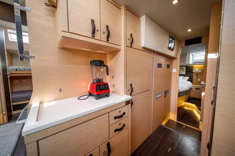 Slide: The Image of Luxurious interior of a 2016 Jeanneau 64 yacht featuring a modern kitchen and cozy bedroom. - 33