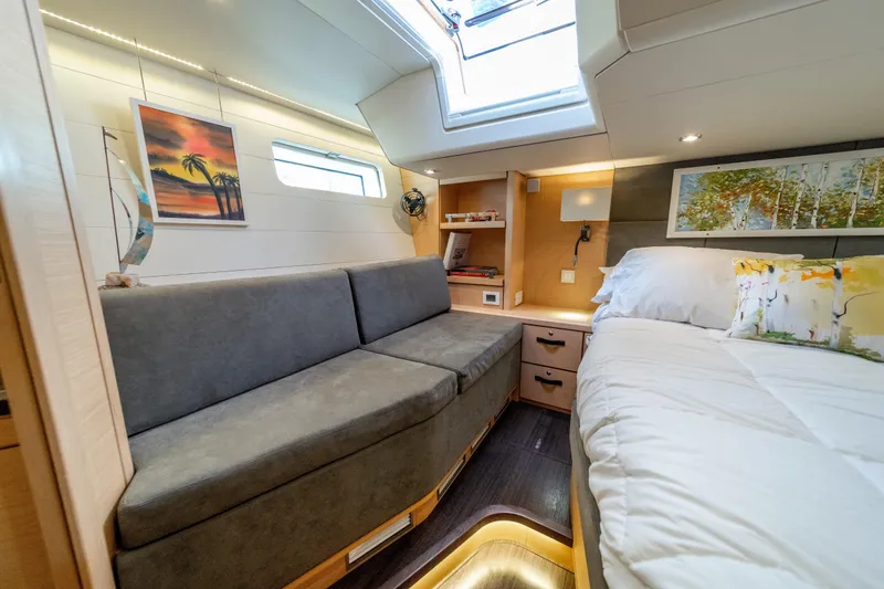 Slide: The Image of Luxurious interior of a 2016 Jeanneau 64 yacht with cozy seating and elegant decor. - 35