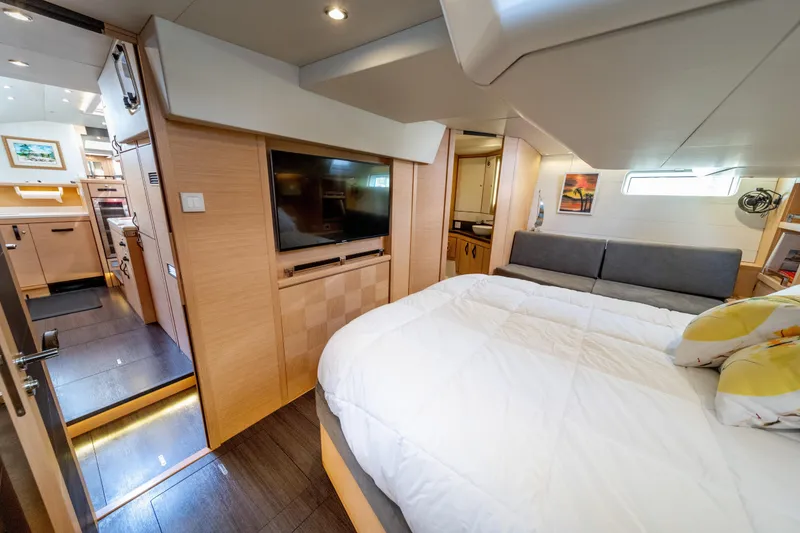 Slide: The Image of Luxurious interior of 2016 Jeanneau 64 yacht featuring a cozy bedroom and modern amenities. - 37
