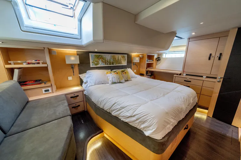 Slide: The Image of Luxurious 2016 Jeanneau 64 yacht bedroom with modern design and cozy bedding. - 38