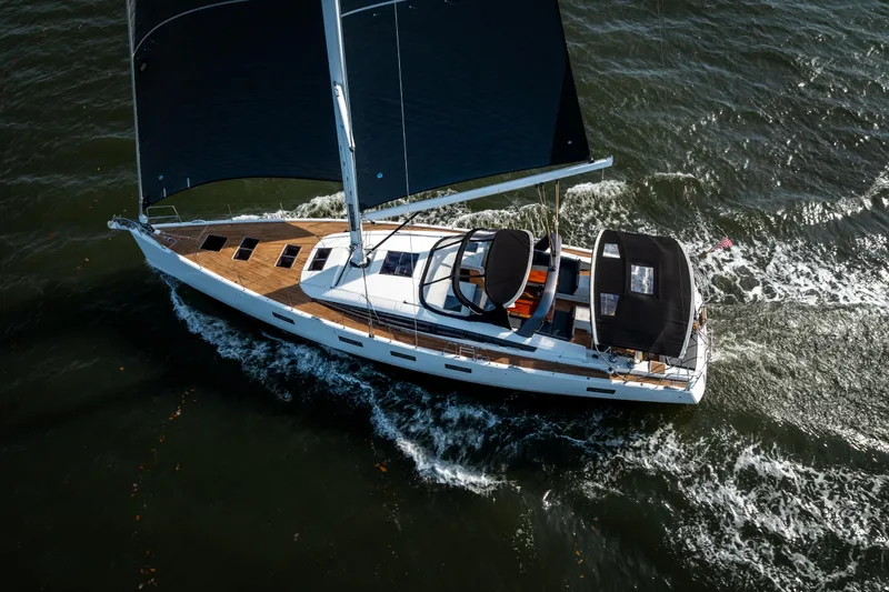 Slide: The Image of 2016 Jeanneau 64 sailing yacht cruising on open water, aerial view. - 4