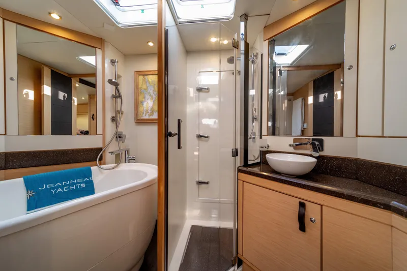 Slide: The Image of Luxurious bathroom on a 2016 Jeanneau 64 yacht with bathtub and modern fixtures. - 44