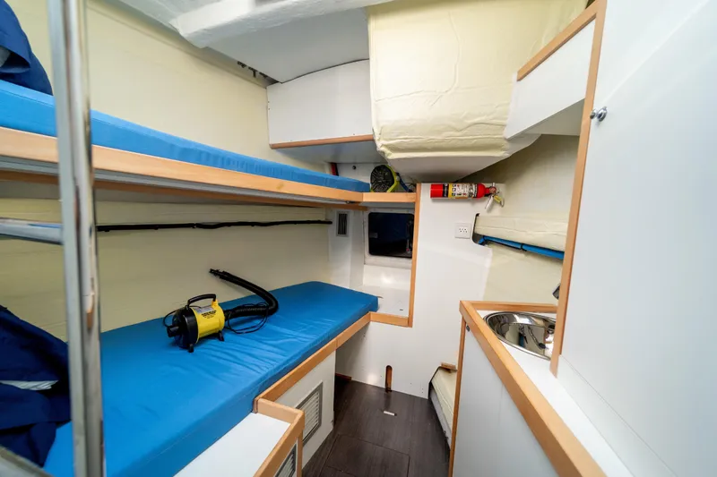 Slide: The Image of Interior of 2016 Jeanneau 64 yacht with bunk beds and compact kitchenette. - 47
