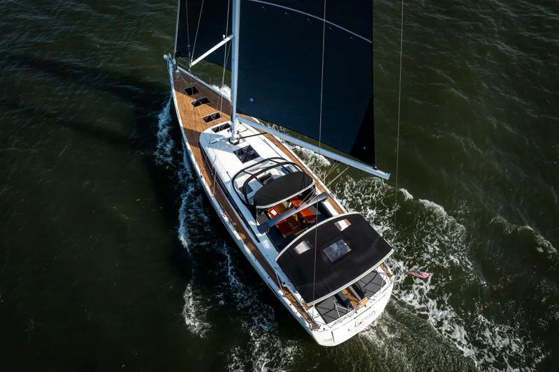 Slide: The Image of Aerial view of 2016 Jeanneau 64 sailboat navigating through water. - 5