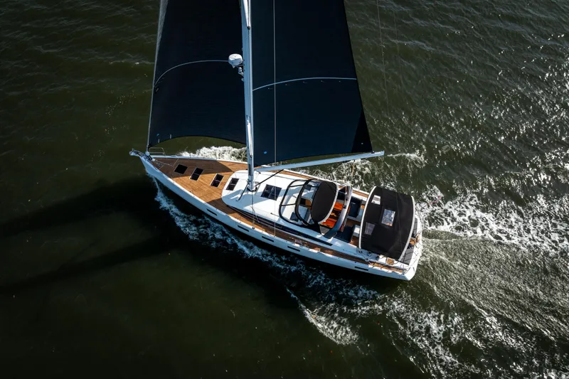Slide: The Image of Aerial view of 2016 Jeanneau 64 sailing yacht on open water. - 6