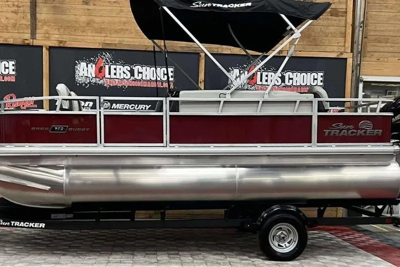 The Image of 2026 Sun Tracker Bass Buggy 18 DLX pontoon boat displayed indoors. - 1