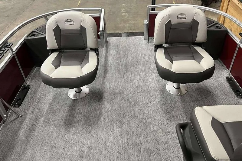 Slide: The Image of 2026 Sun Tracker Bass Buggy 18 DLX interior with two swivel seats on gray carpet. - 4