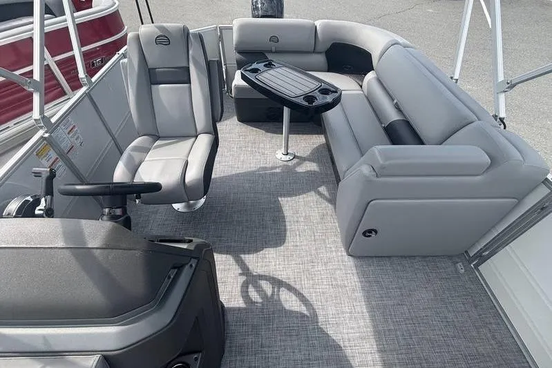 Slide: The Image of 2026 Sun Tracker PB 20 DLX pontoon boat interior with gray seating and table. - 4
