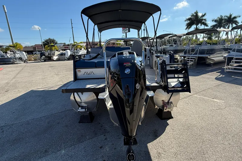 Slide: The Image of 2026 Avalon 2585 LSZ Entertainer Tri Toon boat with high-performance features, parked outdoors. - 10