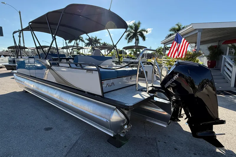 Slide: The Image of 2026 Avalon 2585 LSZ Entertainer Tri Toon boat with Mercury engine, docked under sunny skies. - 11