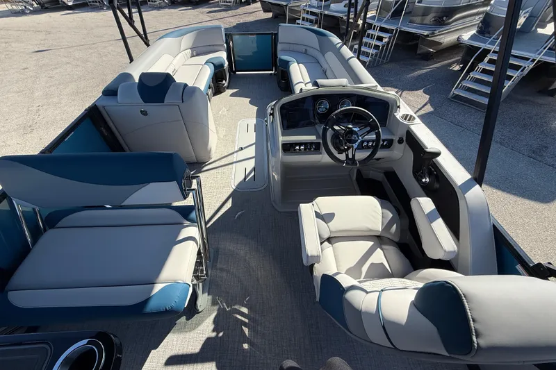 Slide: The Image of 2026 Avalon 2585 LSZ Entertainer Tri Toon boat interior with luxurious seating and helm. - 14