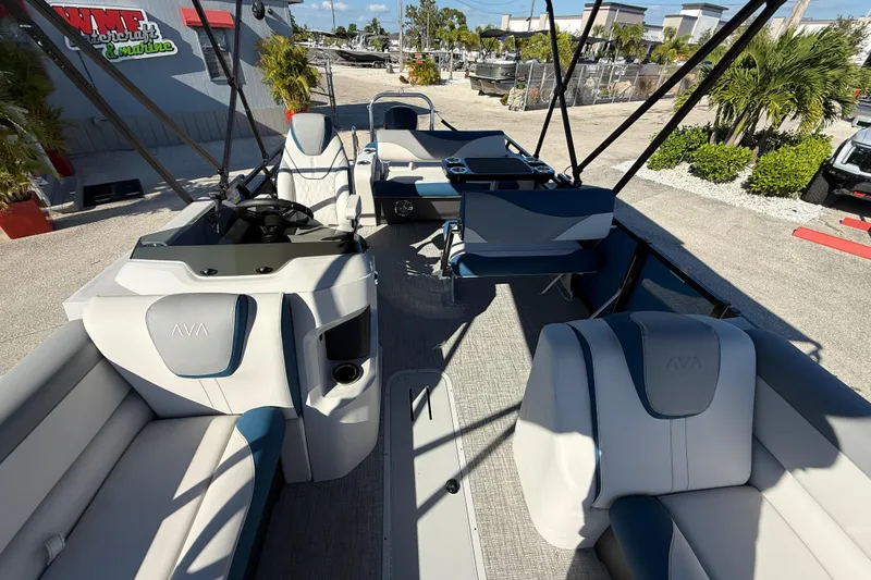 Slide: The Image of 2026 Avalon 2585 LSZ Entertainer Tri Toon boat interior with luxurious seating and helm. - 18