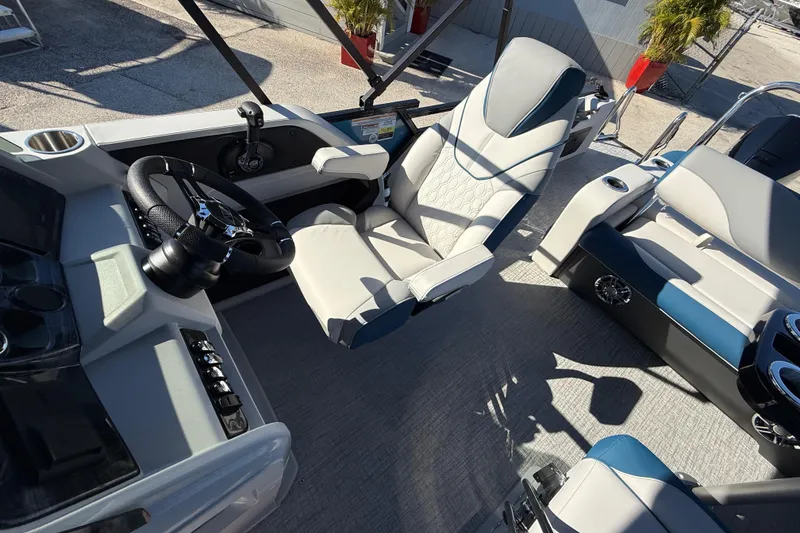 Slide: The Image of 2026 Avalon 2585 LSZ Entertainer boat interior with modern seating and steering wheel. - 20