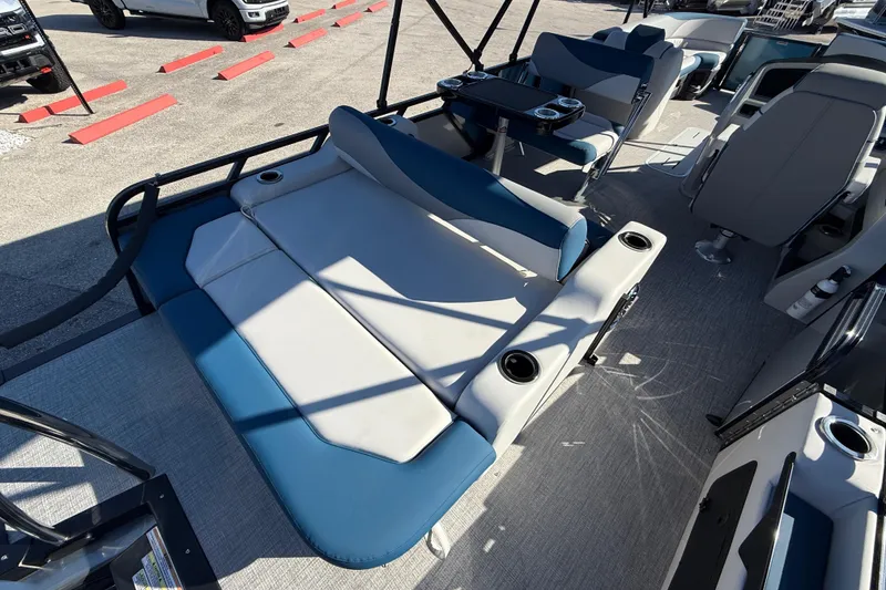 Slide: The Image of 2026 Avalon 2585 LSZ Entertainer boat interior with blue and white seating, cup holders. - 24