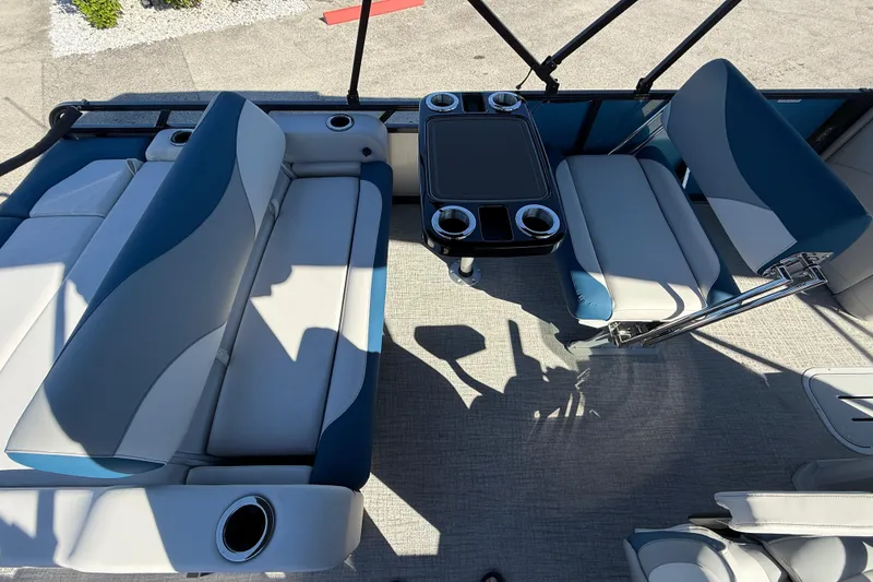 Slide: The Image of Luxurious seating area on 2026 Avalon 2585 LSZ Entertainer Tri Toon boat with table and cup holders. - 25