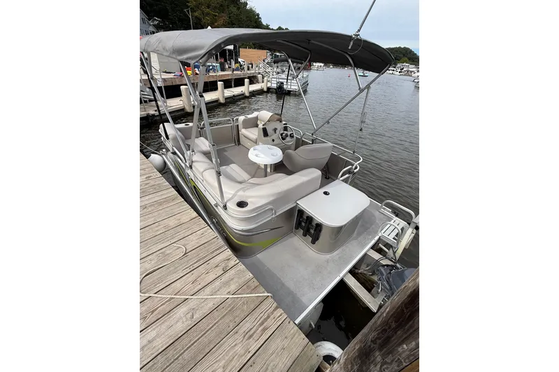 Slide: The Image of 2016 Qwest Adventure 7514 Cruise Deluxe pontoon boat docked at marina. - 2